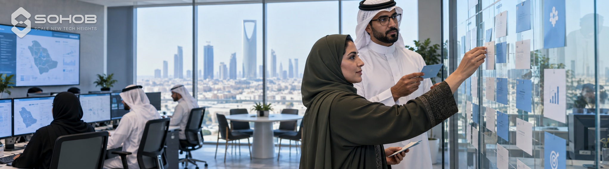 Saudi professionals collaborating on a transparent planning board.